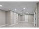 Spacious unfinished basement ready for customization, with new flooring, ample lighting, and multiple access points at 6743 Fox Ridge Cir, Davidson, NC 28036