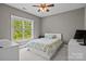 Cozy bedroom with a large window, ceiling fan, and neutral decor, creating a relaxing and inviting space at 6743 Fox Ridge Cir, Davidson, NC 28036