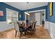 Formal dining room with a wooden table, six chairs, wainscoting and blue walls at 6743 Fox Ridge Cir, Davidson, NC 28036