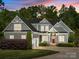 Charming two-story home with gray siding, white trim, a red front door, and a well-manicured front yard at 6743 Fox Ridge Cir, Davidson, NC 28036