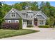Charming two-story home with gray siding, white trim, a red front door, and a well-manicured front yard at 6743 Fox Ridge Cir, Davidson, NC 28036