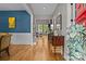 Hallway with hardwood floors, blue accent wall, and decorative console table leading to the living area at 6743 Fox Ridge Cir, Davidson, NC 28036