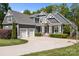 Attractive home with a three-car garage, well-manicured landscaping, and covered front porch at 6743 Fox Ridge Cir, Davidson, NC 28036
