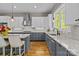 Modern kitchen with stainless steel appliances, granite countertops, and stylish hanging lights at 6743 Fox Ridge Cir, Davidson, NC 28036