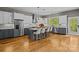 Spacious kitchen with stainless steel appliances, hardwood floors, and a large island with chairs at 6743 Fox Ridge Cir, Davidson, NC 28036