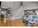 Open-concept living area with hardwood floors, a staircase, and seamless flow into the kitchen and dining space at 6743 Fox Ridge Cir, Davidson, NC 28036
