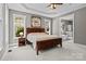 Spacious main bedroom with a large window, ceiling fan, and access to the ensuite bathroom with soaking tub at 6743 Fox Ridge Cir, Davidson, NC 28036