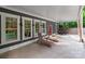Large covered patio with seating, lounge chairs, and outdoor dining set, great for outdoor relaxation at 6743 Fox Ridge Cir, Davidson, NC 28036