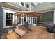 Relaxing patio with lounge chairs, an umbrella, and a screened-in porch for outdoor enjoyment at 6743 Fox Ridge Cir, Davidson, NC 28036