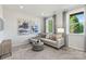 An elegant living room includes neutral furnishings, tasteful artwork, bright natural light, and plush carpet at 7108 Brookview Ln, Sherrills Ford, NC 28673