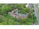 Aerial view of townhomes nestled among trees, with parking and community green spaces at 8221 Pineville Matthews Rd # A, Charlotte, NC 28226