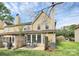 Backyard showing a patio area with chairs, a well-maintained lawn, and partial fencing at 8221 Pineville Matthews Rd # A, Charlotte, NC 28226