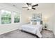 Bright bedroom with neutral walls, carpet, large windows, and a comfortable bed with matching nightstands at 8221 Pineville Matthews Rd # A, Charlotte, NC 28226