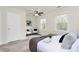 Spacious bedroom with neutral carpet, two windows, white walls, and a comfortable bed with decorative pillows at 8221 Pineville Matthews Rd # A, Charlotte, NC 28226