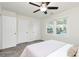 Bright bedroom featuring a ceiling fan, carpet, and large windows offering neighborhood views at 8221 Pineville Matthews Rd # A, Charlotte, NC 28226