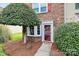 Close-up of the front entry, showcasing a decorative wreath and manicured landscaping around the walkway at 8221 Pineville Matthews Rd # A, Charlotte, NC 28226