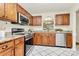 Updated kitchen featuring stainless steel appliances, granite countertops, and classic wooden cabinets, offering both style and functionality at 8221 Pineville Matthews Rd # A, Charlotte, NC 28226