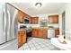 Spacious kitchen with stainless steel appliances, granite countertops, and white tile flooring for a clean, inviting look at 8221 Pineville Matthews Rd # A, Charlotte, NC 28226