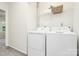 Laundry room with white washer and dryer, wire shelving, and neutral walls at 8221 Pineville Matthews Rd # A, Charlotte, NC 28226