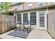 Outdoor patio with rocking chairs, striped rug, and access to the home's interior at 8221 Pineville Matthews Rd # A, Charlotte, NC 28226