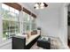 Bright sunroom with large windows, comfortable seating, and a coffee table is perfect for relaxing at 8221 Pineville Matthews Rd # A, Charlotte, NC 28226
