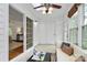 Bright sunroom features tile flooring, white walls, a ceiling fan, and sliding doors to the living area at 8221 Pineville Matthews Rd # A, Charlotte, NC 28226