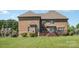 Brick home with expansive backyard, wood deck, and well-manicured lawn at 9008 Skipaway Dr, Waxhaw, NC 28173