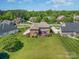 Expansive backyard featuring a well-maintained lawn, lovely landscaping and wood deck, perfect for outdoor living at 9008 Skipaway Dr, Waxhaw, NC 28173