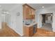 Elegant bar area with wooden cabinets, granite counters, and stainless steel beverage cooler at 9008 Skipaway Dr, Waxhaw, NC 28173