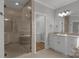 Spa-like bathroom features a glass enclosed shower, double vanity, and walk-in closet at 9008 Skipaway Dr, Waxhaw, NC 28173