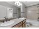 Well-lit bathroom featuring a double vanity with granite countertop and neutral ceramic tile at 9008 Skipaway Dr, Waxhaw, NC 28173
