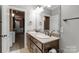 Bathroom featuring a double sink vanity with granite countertops and framed mirror at 9008 Skipaway Dr, Waxhaw, NC 28173