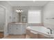 Relaxing bathroom featuring soaking tub, granite vanity, and great natural light at 9008 Skipaway Dr, Waxhaw, NC 28173