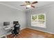 Bedroom with hardwood floors, a ceiling fan, and a built-in desk for a great workspace at 9008 Skipaway Dr, Waxhaw, NC 28173