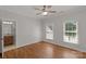 Bedroom with hardwood floors and natural light from two bright windows at 9008 Skipaway Dr, Waxhaw, NC 28173