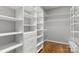 Walk-in closet with custom shelving and drawers at 9008 Skipaway Dr, Waxhaw, NC 28173