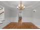 Formal dining room featuring hardwood floors, wainscoting, and a chandelier at 9008 Skipaway Dr, Waxhaw, NC 28173