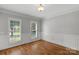 Bright and airy room with two windows, hardwood floors, and wainscoting at 9008 Skipaway Dr, Waxhaw, NC 28173