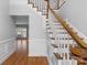 Spacious foyer with wood floors, a staircase, and wainscoting at 9008 Skipaway Dr, Waxhaw, NC 28173