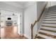Elegant foyer featuring hardwood floors, a staircase, and a view into the living room with fireplace at 9008 Skipaway Dr, Waxhaw, NC 28173