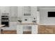 Built-in desk with custom cabinets, granite counters, and decorative plants in this luxurious, light-filled kitchen at 9008 Skipaway Dr, Waxhaw, NC 28173