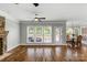 Open-concept living room features hardwood floors, large windows, and a stone fireplace at 9008 Skipaway Dr, Waxhaw, NC 28173
