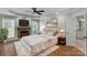 Cozy main bedroom featuring a fireplace, tray ceiling, and plush carpet at 9008 Skipaway Dr, Waxhaw, NC 28173