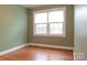 Sunlit bedroom featuring a large window and hardwood floors at 920 N Sixth St, Albemarle, NC 28001