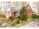Charming brick home with a well-maintained front yard, mature trees, and inviting front porch at 920 N Sixth St, Albemarle, NC 28001