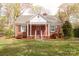 Beautiful brick house with a classic design, featuring a covered porch and well-manicured lawn at 920 N Sixth St, Albemarle, NC 28001