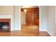 Bright living room featuring hardwood floors, fireplace with tile surround, and arched doorway to dining area at 920 N Sixth St, Albemarle, NC 28001