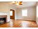 Spacious living room with hardwood floors, fireplace, and abundant natural light from large windows at 920 N Sixth St, Albemarle, NC 28001
