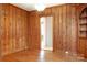 Inviting living room featuring wood-paneled walls, hardwood floors, and built-in shelves at 920 N Sixth St, Albemarle, NC 28001
