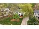 An aerial view of a two-story home with mature trees, green lawn, and convenient driveway at 9319 Harps Mill Ct, Charlotte, NC 28270